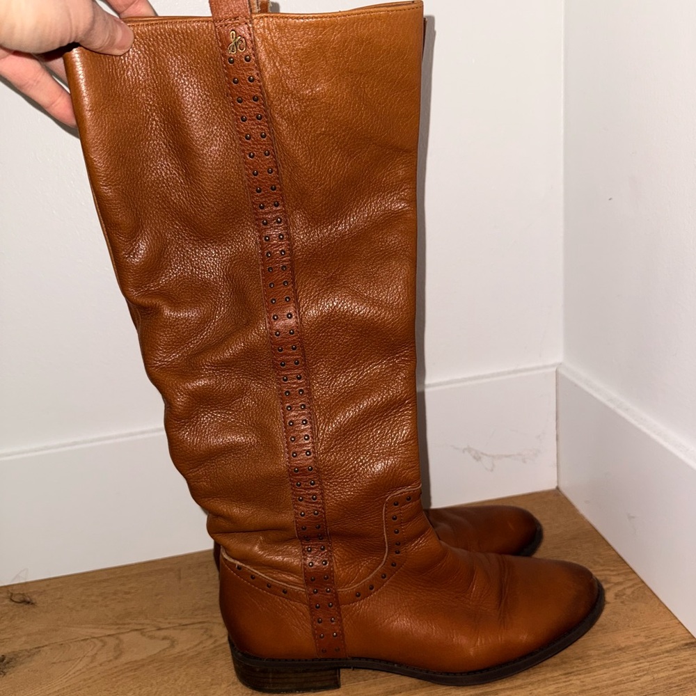 Tall brownish-orange leather boot with a slightly slouchy shaft.